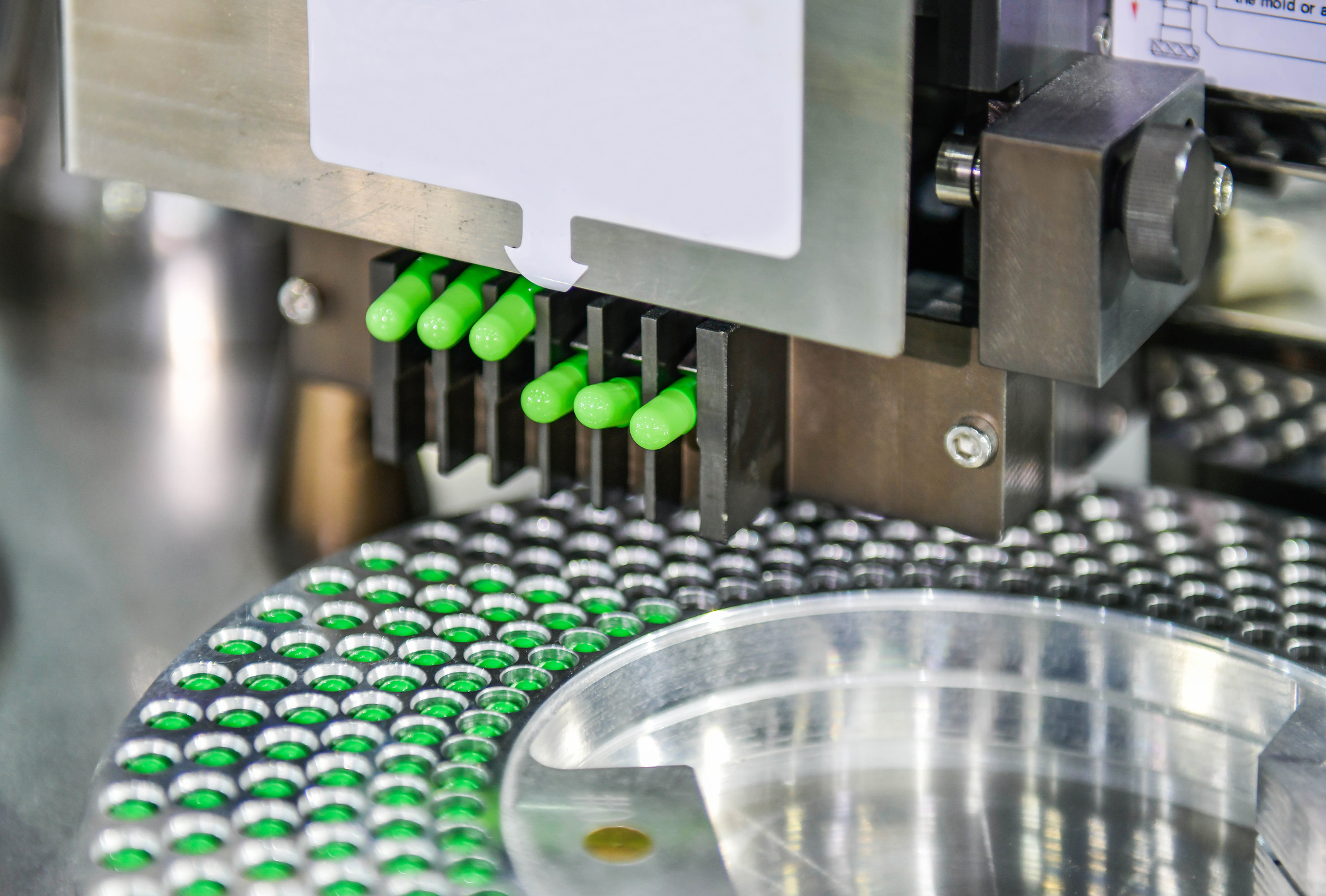 Green capsule medicine pill production line, Industrial pharmaceutical concept.